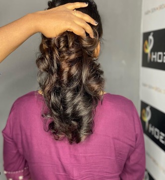 Bridal hair styled into a curled half-updo
