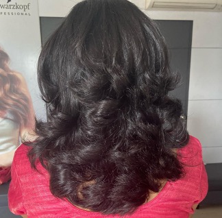 Hair set into soft curls for a wedding function