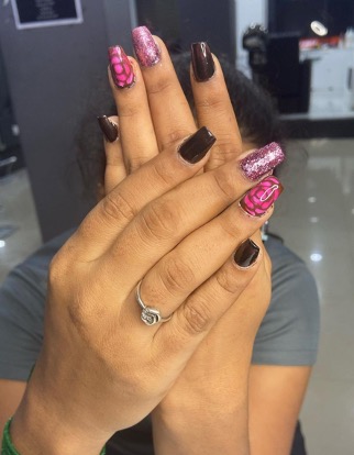 Nail art with glitter and hand-painted detail