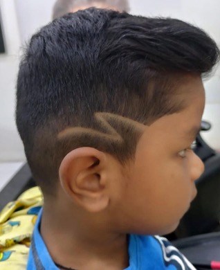 Boy's haircut with a hair-art design at the side